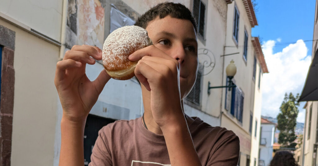 Alfie tucks into a donut from Padaria Sésamo.