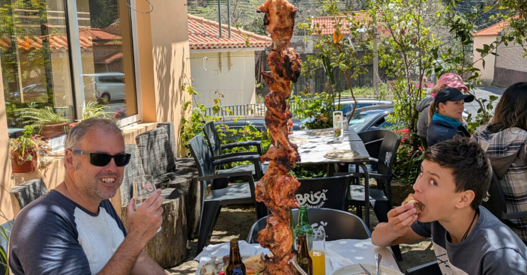John and Alfie enjoy a meal of espetada (bbq'd meat skewers).