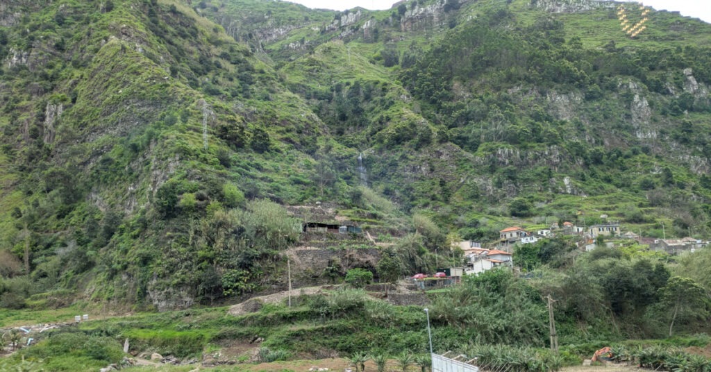 Valley views of terraced fields and houses dotted up the steep mountainside.